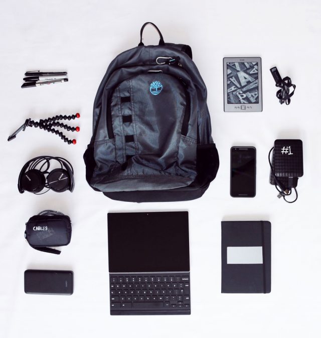 flat lay of electronics and travel bag