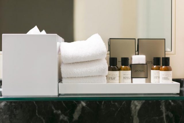 hotel toiletries and hand towels in bathroom